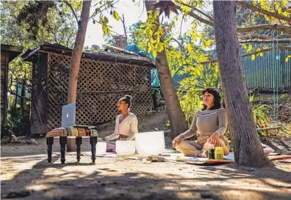  ?? DANIA MAXWELL LOS ANGELES TIMES ?? Aqueene Simran (right) leads a virtual yoga class with Nicole Ballantine at GreenStone Farm and Sanctuary in Mount Washington in Los Angeles. The space is open to one’s own use for an hour or more of personal time and is typically booked online.