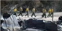  ?? The Associated Press ?? Firefighte­rs arrive at decimated Paramount Ranch for a meeting with U.S. Secretary of the Interior Ryan Zinke on Thursday.