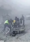  ?? SUPPLIED PHOTO/THE ASSOCIATED PRESS ?? Civil Defense workers carry an injured man after government airstrikes hit Douma, near Damascus, Syria, on Sunday.