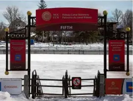  ?? DAVE CHAN/AFP VIA GETTY IMAGES ?? A closed gate prevents access to the Rideau Canal Skateway in Ottawa, the longest rink in the world. It may be the first winter since the skateway formally opened in 1971 that skaters won’t be able to traverse it.