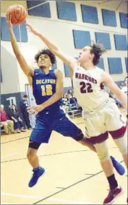  ?? Westside Eagle Observer/MIKE ECKELS ?? Tarfari James (Decatur 12) fights to put up a jumper while Conner Floyd (Warriors 22) tries for a steal during the Life WayDecatur boys’ basketball contest on Jan. 8.