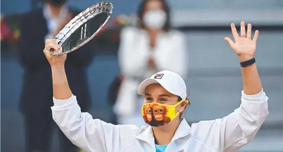  ??  ?? Ash Barty poses with her trophy after being beaten by Belarus's Aryna Sabalenka during their 2021 WTA Tour Madrid Open final. Picture AFP