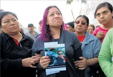  ?? Gary Coronado Los Angeles Times ?? JENNIFER RUIZ, 26, attends a vigil for her mother, Rosa “Rosalba” Ruiz, who was among 13 people killed in a bus crash near Palm Springs early Sunday. The tour bus, returning to L.A., struck a big rig on the 10 Freeway.