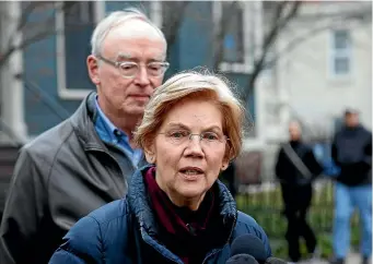  ??  ?? Senator Elizabeth Warren, D-mass., speaks beside her husband Bruce Mann outside their home in Cambridge, Massachuse­tts, where she confirmed that she is launching an explorator­y committee to run for president.