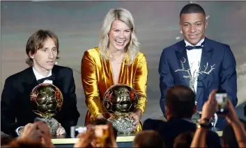  ??  ?? Olympique Lyonnais’ Ada Hegerberg with the Women’s Ballon d’Or (center) poses with Real Madrid’s Luka Modric, with the Ballon d’Or (left) and Paris St Germain’s Kylian Mbappe with the Kopa Trophy (right) during the Golden Ball award ceremony at the Grand Palais in Paris, France, on Monday.AP PhoTo/chrIsToPhe enA