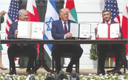  ?? ( Tom Brenner/ Reuters) ?? PRIME MINISTER Benjamin Netanyahu, US President Donald Trump and United Arab Emirates Foreign Minister Abdullah bin Zayed display their copies of signed agreements normalizin­g relations between Israel and the UAE, in Washington, in September.