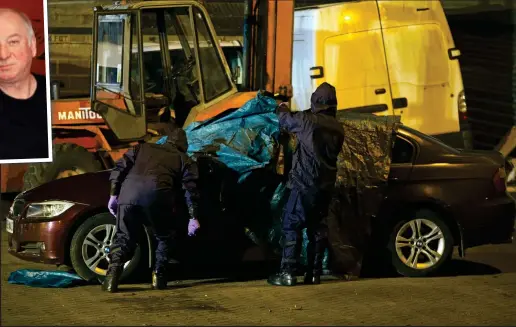  ??  ?? Hunt for clues: Specialist police officers search a BMW, believed to be Mr Skripal’s, at a garage in Salisbury