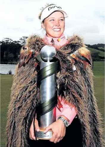  ?? GETTY IMAGES ?? Brooke Henderson, of Smiths Falls, Ont., poses wearing a Maori cloak and holds the winner’s trophy after winning the inaugural New Zealand Women’s Open in October in Auckland, New Zealand.