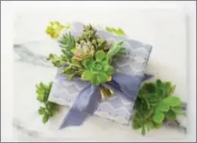  ?? COURTESY WRAPPILY ?? Trimmings from succulents make festive decoration­s for gifts and they’re bio-degradable — unlike many bows and adornments.