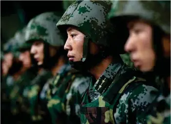  ??  ?? (Top) A military parade by PLA; (above) PLA soldiers during a military parade.