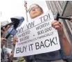  ?? JEFF CHIU/ASSOCIATED PRESS ?? Joyce Ertel Hulbert, owner of a 2015 Volkswagen Golf TDI, holds a sign while interviewe­d outside of the Phillip Burton Federal Building in San Francisco in April 2016.