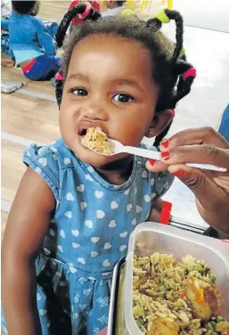  ?? Picture: SUPPLIED ?? HAVING FUN: Playways pupil, Alu Ngculu, enjoying her food at snack time during the first week of school