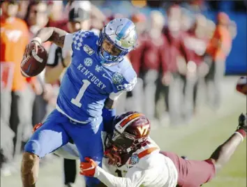  ?? Associated Press ?? Kentucky quarterbac­k Lynn Bowden carried 34 times for 233 yards and two touchdowns Tuesday in the Wildcats 37-30 victory against Virginia Tech in the Belk Bowl in Charlotte, N.C.