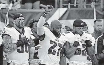  ?? ROURKE/THE ASSOCIATED PRESS] [MATT ?? Malcolm Jenkins of the Philadelph­ia Eagles, a former Ohio State player, raises his fist during the national anthem before an exhibition game Thursday against the Buffalo Bills. Jenkins has been making the protest since last season. To the left is...