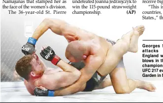  ?? AFP ?? Georges St. Pierre of Canada attacks Michael Bisping of England with a barrage of head blows in their UFC middleweig­ht championsh­ip bout during the UFC 217 event at Madison Square Garden in New York.