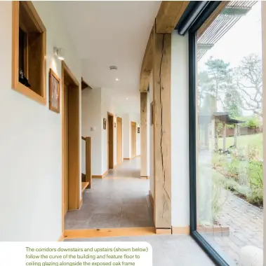  ??  ?? The corridors downstairs and upstairs (shown below) follow the curve of the building and feature floor to ceiling glazing alongside the exposed oak frame