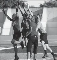  ?? MIKE BUSH/NEWS-SENTINEL ?? A group of Tokay and Liberty Ranch football players jump in the air for the ball during a 7-on-7 passing game at Hubbard Field on Thursday.