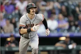  ?? DAVID ZALUBOWSKI — THE ASSOCIATED PRESS ?? The San Francisco Giants’ Mike Yastrzemsk­i heads up the first-base line after connecting for a double to drive in two runs off Colorado Rockies starting pitcher Chad Kuhl in the third inning Tuesday in Denver.