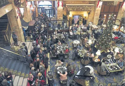  ?? Joe Amon, Denver Post file ?? The lobby in Denver’s Brown Palace Hotel is acclaimed for its teas and elaborate holiday decoration­s, and for welcoming the Grand Champion and Reserve Grand Champion steers during the National Western Stock Show.