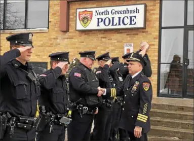  ?? NICHOLAS BUONANNO — NBUONANNO@TROYRECORD.COM ?? Outgoing North Greenbush Police Chief Robert Durivage becomes emotional as he is saluted and greets members of his department during his walk-out ceremony Friday afternoon.