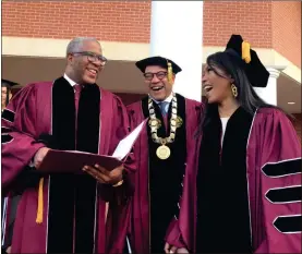  ?? AP-Bo Emerson ?? Robert F. Smith, left, laughs with David Thomas, center, and actress Angela Bassett at Morehouse College on in Atlanta on Sunday. Smith, a billionair­e technology investor and philanthro­pist, said he will provide grants to wipe out the student debt of the entire graduating class at Morehouse College — an estimated $40 million. Smith, this year’s commenceme­nt speaker, made the announceme­nt Sunday morning while addressing nearly 400 graduating seniors of the all-male historical­ly black college in Atlanta.