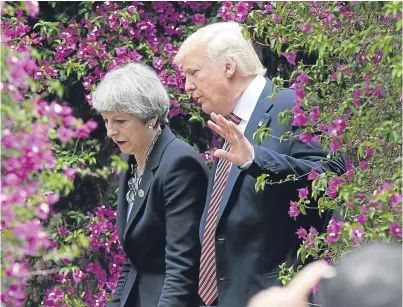  ?? Picture: AP. ?? US President Donald Trump talks with Prime Minister Theresa May in Taormina, Italy.