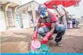  ??  ?? A health worker wearing protective gear mixes water and chlorine in Goma yesterday. — AFP