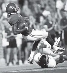  ?? THE ASSOCIATED PRESS ?? Alabama wide receiver Robert Foster falls into the end zone with a touchdown against Colorado State safety Jordan Fogal in the first half of Saturday’s game in Tuscaloosa, Ala.