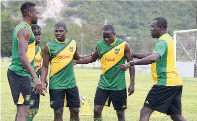  ?? FILE ?? Jamaica senior men’s football team head coach Theodore ‘Tappa’ Whitmore (right) relays instructio­ns to his players during a training session last August.