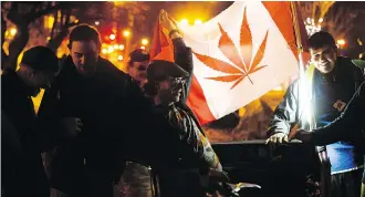  ?? DAVID BLOOM ?? A small group of Edmontonia­ns celebrate marijuana legalizati­on in a park near Whyte Avenue and Gateway Boulevard, early Wednesday morning. The park is one of Edmonton’s new smoking zones.