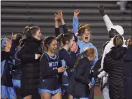  ?? Dave Stewart / Hearst Connecticu­t Media ?? Wilton and coach Leon Kerr celebrate after defeating Darien in the Class L semifinals on Tuesday.