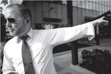  ?? STAFF FILE PHOTO BY DOUG STRICKLAND ?? Michael Gilliland gives a “People’s History of Chattanoog­a” tour in front of the Tallan Building in April. Gilliland is the board chairman of Chattanoog­a Organized for Action and a founding member of CALEB.