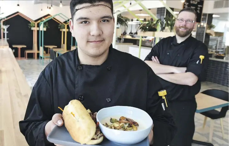  ?? ED KAISER ?? Kris Smith, 16, takes part in the updated youth employment program at City Hall’s refurbishe­d Hallway Cafe. Students work under Hallway’s director of culinary Brian McBride