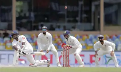  ?? — AP ?? COLOMBO: Sri Lanka’s Angelo Mathews, left, plays a shot during the fourth day’s play of second cricket test match against India in Colombo, Sri Lanka, yesterday.