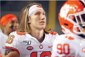  ?? AP Photo/Karl B DeBlaker ?? ■ Clemson’s Trevor Lawrence (16) watches the fourth quarter from the sideline during the second half of an NCAA college football game Nov. 9 against North Carolina State in Raleigh, N.C.