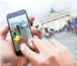  ?? ALEXANDER HEINL, EPA ?? Pokémon Go can be a travel guide, revealing sights you’d otherwise miss.