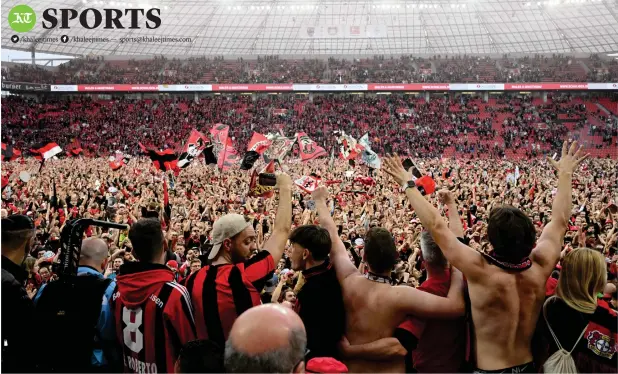 ?? — AFP ?? Leverkusen fans celebrate on the pitch after the team won their first ever German first division title.