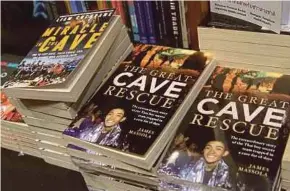  ?? AFP PIC ?? Books relating to the rescue of the 12 boys from the ‘Wild Boars’ football team and their coach seen at a bookstore in Bangkok on Sunday.