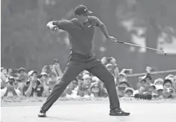  ??  ?? Tiger Woods celebrates his birdie on 18 that led to him finishing second in the PGA Championsh­ip on Sunday.