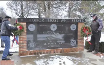  ?? Staff photo/ Jake Dowling ?? Members of the Chained Eagles prepare to lay two wreaths at the veterans memorial at Memorial Park on Saturday as part of Wreaths Across America.