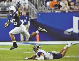  ?? AP PHOTO ?? HIGH, BYE: Penn State’s Saquon Barkley (26) leaps over Washington defensive back Myles Bryant (5) during yesterday’s Fiesta Bowl.