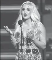  ?? (PHOTO BY CHRIS PIZZELLO/INVISION/AP) ?? Carrie Underwood accepts the award for vocal event of the year for “The Fighter” at the 53rd annual Academy of Country Music Awards at the MGM Grand Garden Arena on Sunday, April 15, 2018, in Las Vegas.