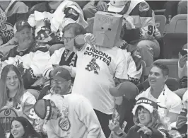  ?? MICHAEL CHOW/THE REPUBLIC ?? An Arizona Coyotes fan wears a bag over his head during their final home game against the Edmonton Oilers at Mullett Arena.