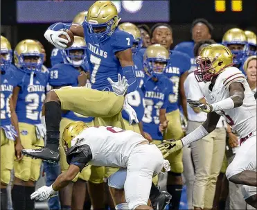  ?? PHOTO BY DANIEL VARNADO ?? McEachern wide receiver Javon Baker leaps over Brookwood safety Alexander Diggs in the first half of their game at Mercedes Benz Stadium on Saturday. Baker had five catches for 142 yards and a touchdown.