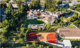  ?? ?? The estate is tucked away in the gated community of Hidden Hills and features an orange basketball court. Photograph: Zillow