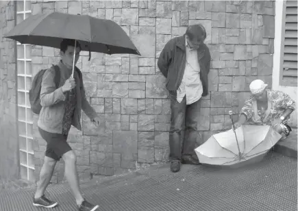  ?? Photo by Milo Brioso ?? TIMELY. An umbrella repairman comes in handy at this time of the year in Baguio City with the continuous rains. A repairman charge P20 to 100 depending on the damage fixed.