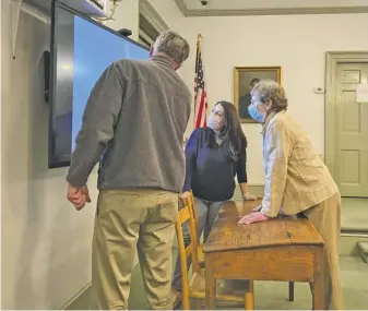  ?? BY LUKE CHRISTOPHE­R ?? Board of Zoning Appeals members Alex Sharp, Steph Ridder and Julie Coonce review a property diagram at last week’s meeting.