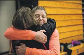  ?? Kent Nishimura Los Angeles Times ?? SHEILA CRAFT, right, admissions and marketing chief at Cypress Meadows, is hugged by coach Gina Snider at Chico High School. Craft lost her home in the fire.