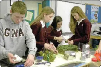  ??  ?? GNA eighth grade students collaborat­e on the 3-D model of a section of their futuristic city, Yardopolis, for the Future City Competitio­n.