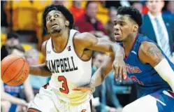  ?? AP PHOTO/JASON E. MICZEK ?? Campbell University guard Chris Clemons drives to the basket against Presbyteri­an’s Chris Martin during a game in January. Clemons, who is 5-foot-9, leads the nation in scoring with a 29.1 average.